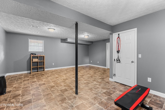 basement featuring a textured ceiling