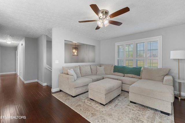 living room featuring a textured ceiling, wood-type flooring, and ceiling fan