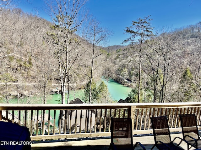 deck featuring a water view and area for grilling