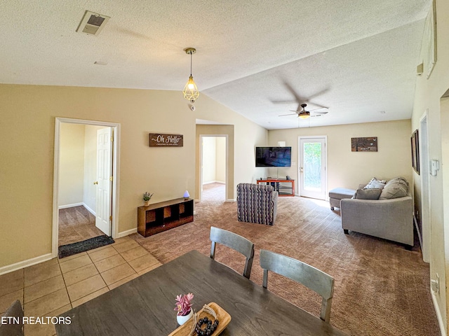 dining area with tile patterned floors, visible vents, carpet floors, and a textured ceiling