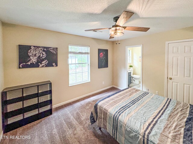 carpeted bedroom with connected bathroom, a textured ceiling, and baseboards