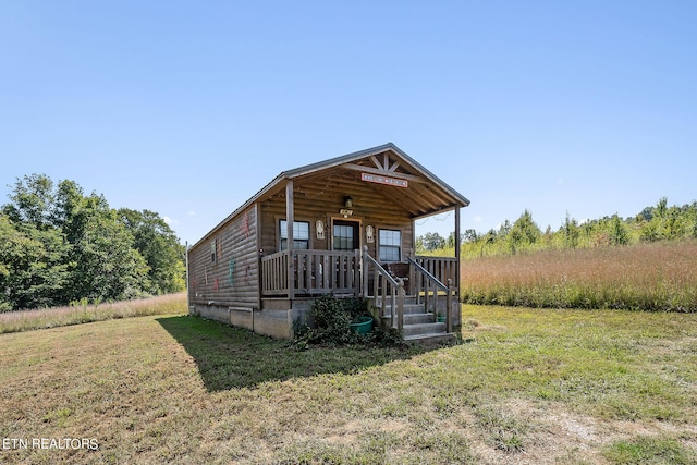 exterior space with a yard and covered porch