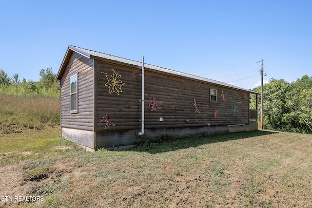 view of side of home with a yard