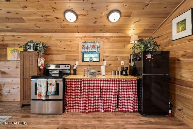 interior space featuring stainless steel electric range oven, hardwood / wood-style flooring, wooden ceiling, lofted ceiling, and black refrigerator