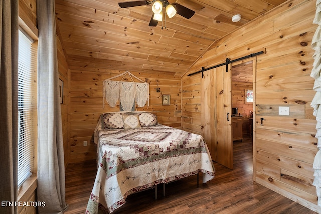 bedroom with wood walls, hardwood / wood-style floors, wood ceiling, a barn door, and ceiling fan