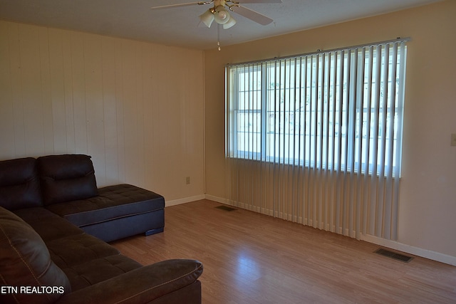 living room featuring light wood-type flooring and ceiling fan