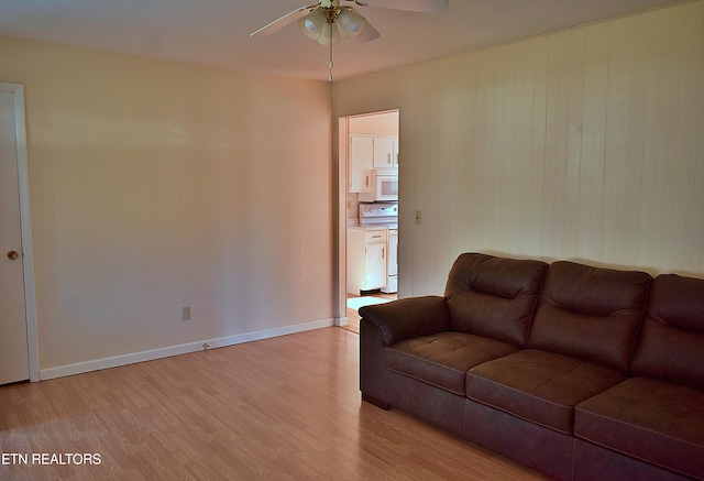 living room featuring light wood-type flooring and ceiling fan