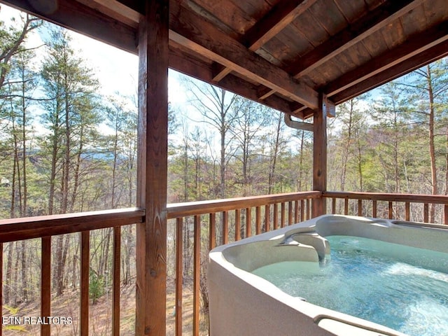 wooden deck with a hot tub