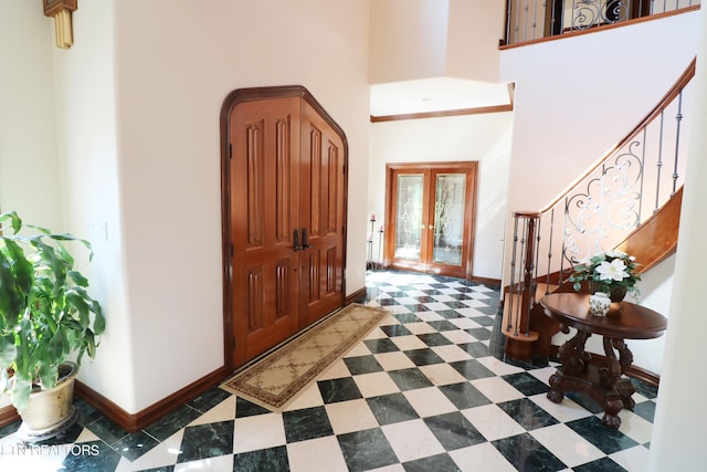 entrance foyer with a high ceiling and french doors