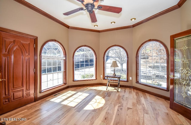 interior space featuring light hardwood / wood-style flooring, ceiling fan, and ornamental molding