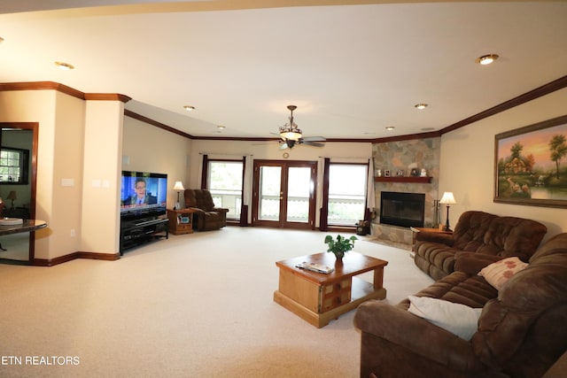 carpeted living room featuring ceiling fan, a fireplace, and ornamental molding