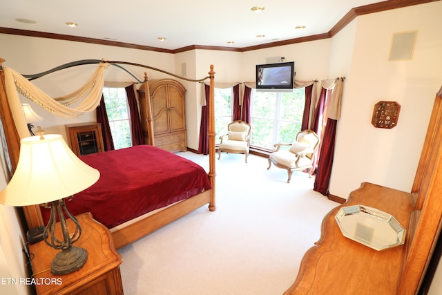 bedroom with multiple windows, crown molding, and carpet floors