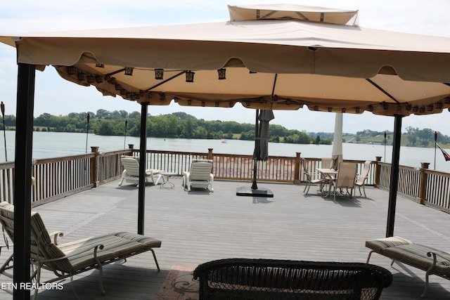 wooden deck with a water view and a gazebo