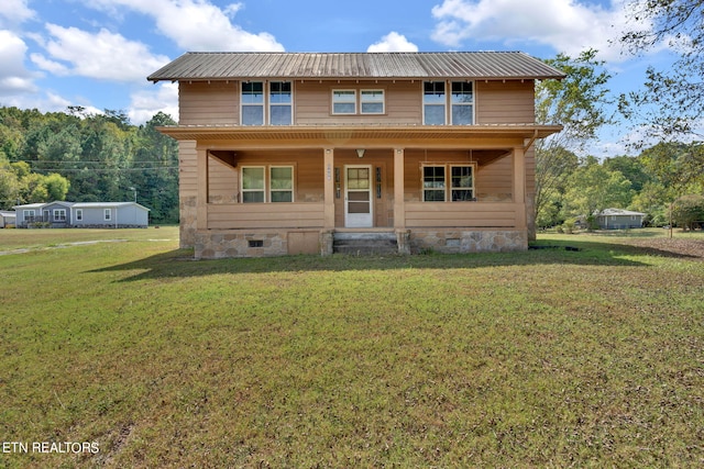 view of front of house with a front yard and a porch