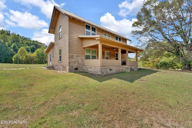 back of house featuring metal roof, crawl space, and a lawn