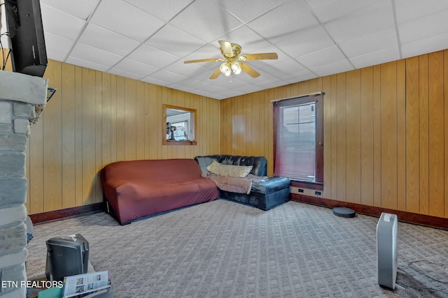 living area with carpet floors, ceiling fan, and a paneled ceiling