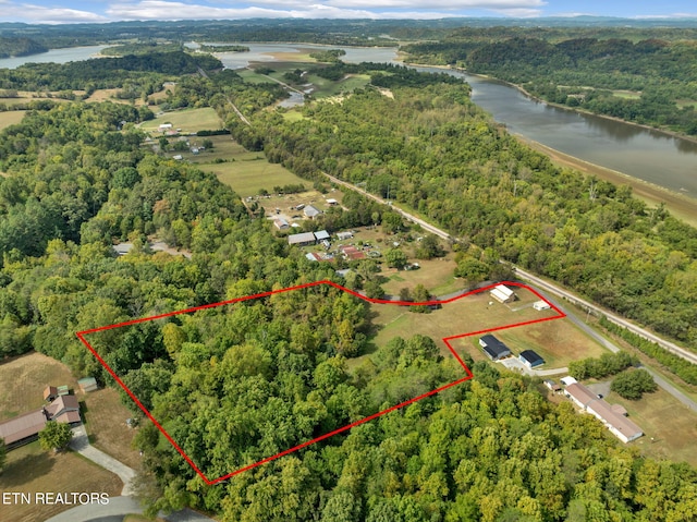 aerial view with a water view and a wooded view