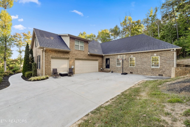 view of front facade featuring crawl space, driveway, brick siding, a garage, and a shingled roof