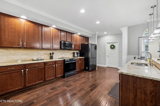 kitchen featuring stainless steel microwave, backsplash, freestanding refrigerator, a sink, and range with electric cooktop