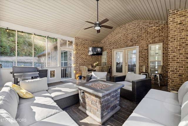 view of patio / terrace with french doors, a ceiling fan, and an outdoor living space with a fire pit