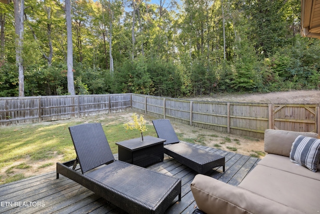 wooden deck featuring an outdoor hangout area and a fenced backyard