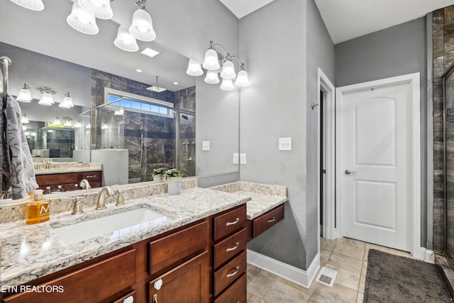 bathroom with visible vents, a shower stall, baseboards, vanity, and tile patterned flooring