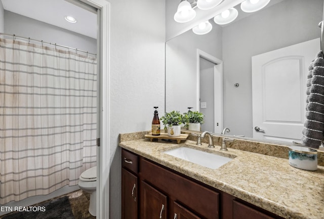 full bathroom with toilet and vanity