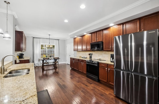 kitchen with tasteful backsplash, electric stove, a sink, freestanding refrigerator, and light stone countertops