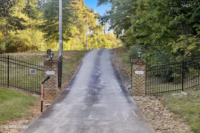 view of street featuring a gate and street lighting