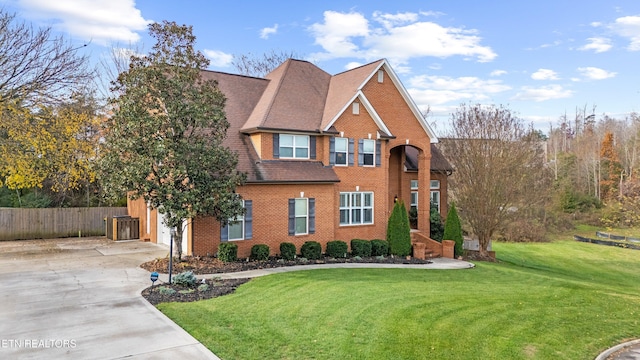 view of front of property featuring a front yard and a garage