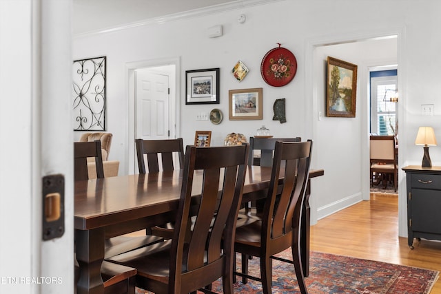 dining room featuring hardwood / wood-style flooring and ornamental molding