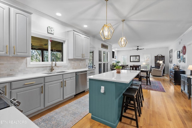 kitchen featuring dishwasher, gray cabinets, ceiling fan, and sink