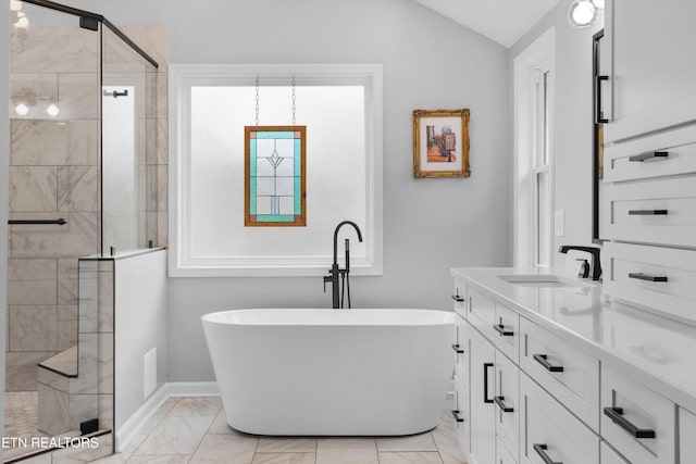 bathroom featuring vanity, separate shower and tub, and vaulted ceiling