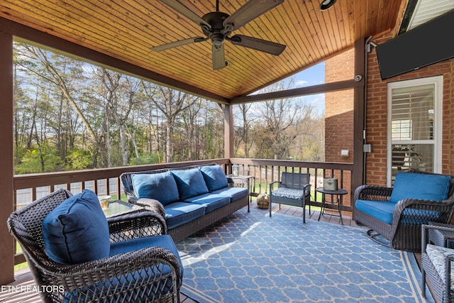 exterior space with an outdoor living space and ceiling fan