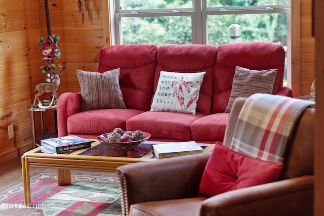 living room with hardwood / wood-style flooring and wooden walls