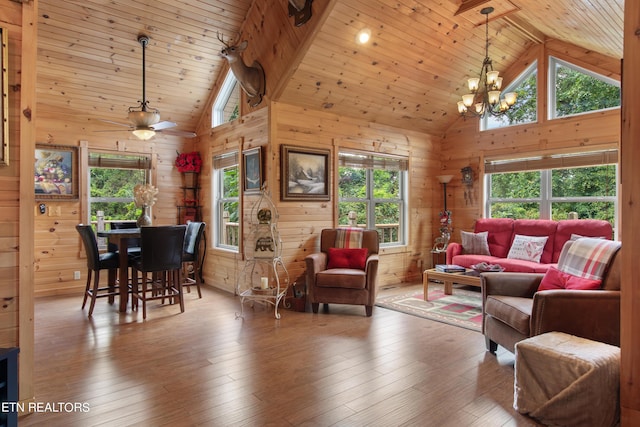 living room featuring high vaulted ceiling, ceiling fan with notable chandelier, hardwood / wood-style flooring, and wooden ceiling