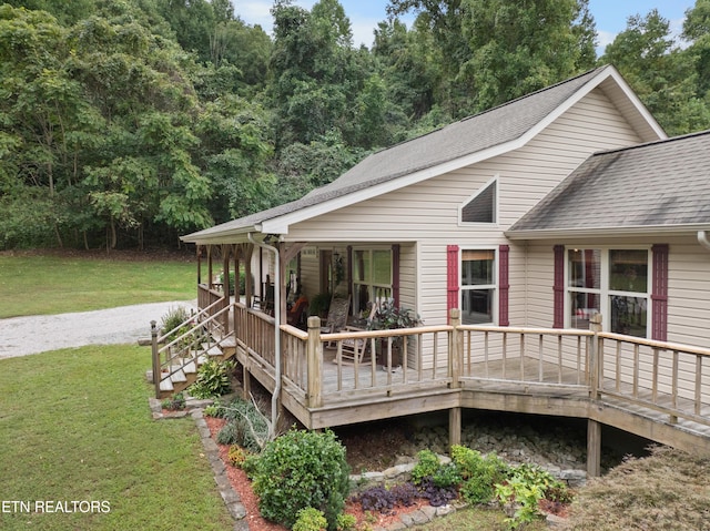 exterior space with covered porch and a front yard