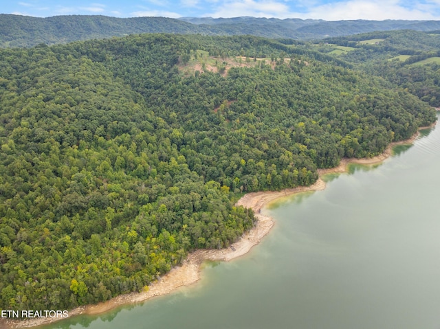 aerial view featuring a water and mountain view