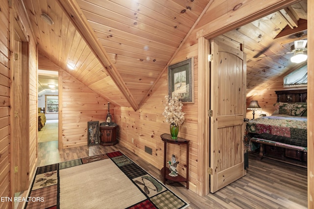 bonus room featuring wooden ceiling, hardwood / wood-style floors, and wooden walls