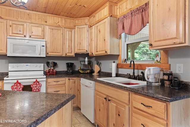 kitchen with light tile patterned flooring, white appliances, light brown cabinetry, and sink