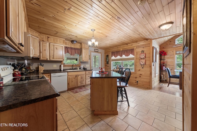 kitchen with black range, white dishwasher, sink, a kitchen breakfast bar, and a kitchen island