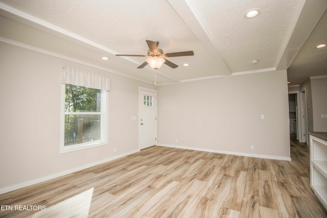 interior space featuring ceiling fan, light hardwood / wood-style flooring, a textured ceiling, and crown molding