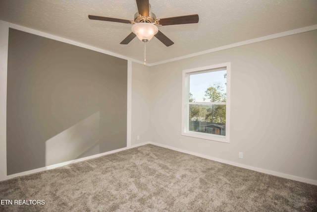 carpeted empty room featuring ceiling fan, a textured ceiling, and ornamental molding