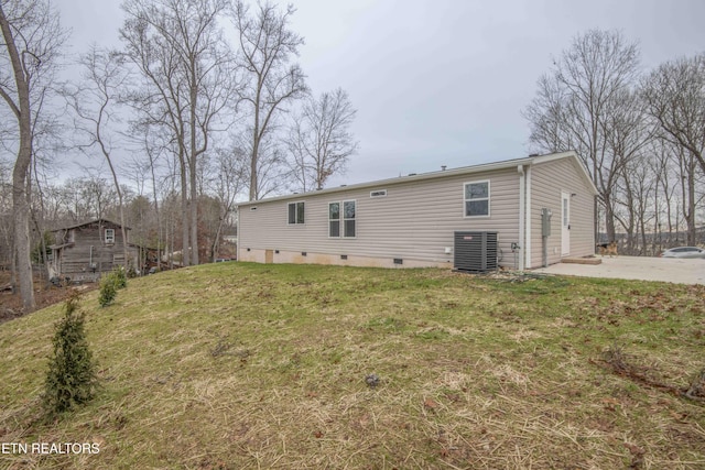 back of house with a patio area, central AC, and a yard