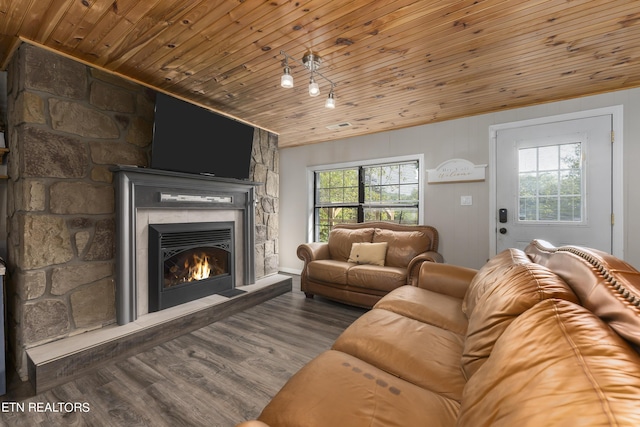 living room featuring a stone fireplace, wood ceiling, and hardwood / wood-style flooring