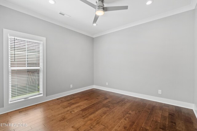 spare room with hardwood / wood-style floors, crown molding, and ceiling fan