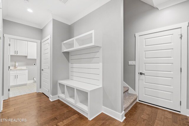 mudroom with hardwood / wood-style flooring and ornamental molding