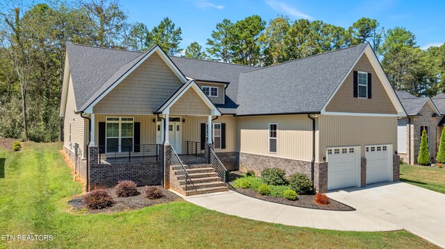 craftsman-style house with a porch, a front yard, and a garage