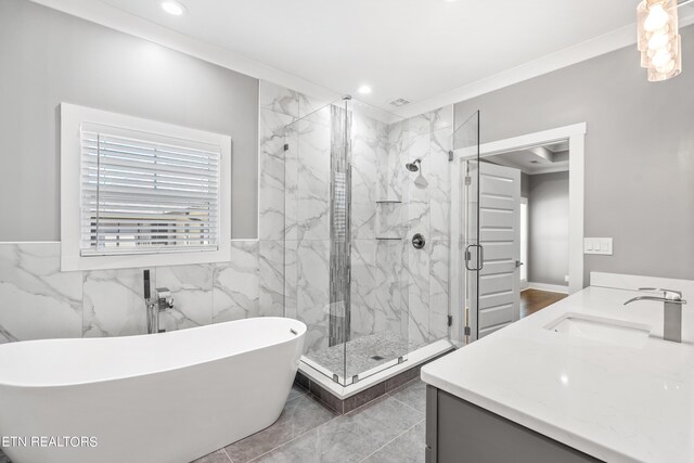 bathroom with vanity, crown molding, plus walk in shower, and tile walls