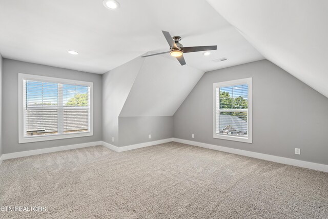 bonus room featuring lofted ceiling, carpet floors, and ceiling fan